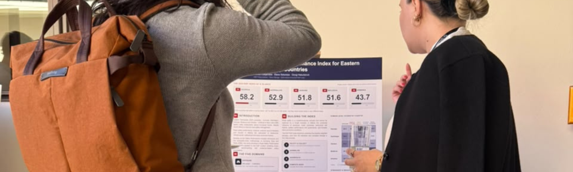 Mariam explaining Index poster to researcher